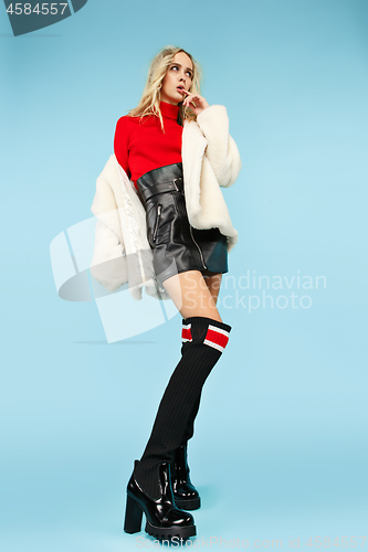 Image of Full-length portrait young elegant woman at studio. Female fashion and shopping concept