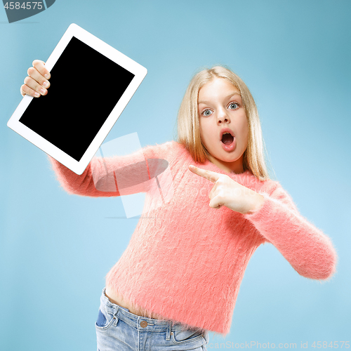 Image of Little funny girl with tablet on blue background