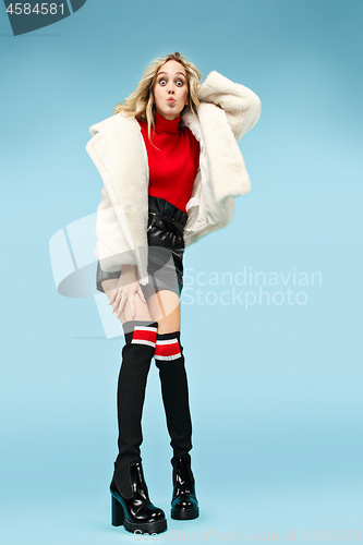 Image of Full-length portrait young elegant woman at studio. Female fashion and shopping concept