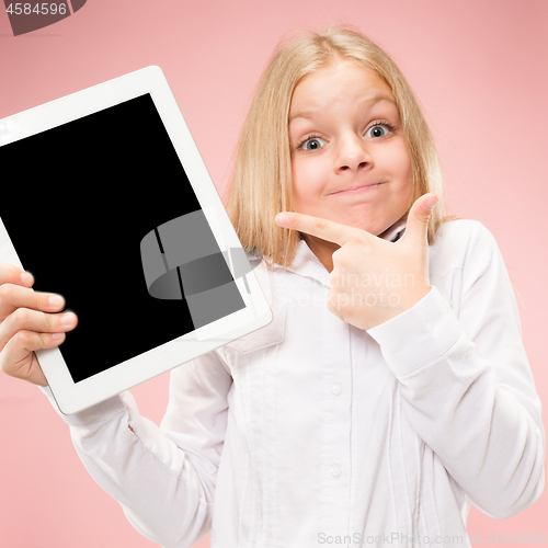 Image of Little funny girl with tablet on pink background