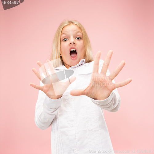 Image of Portrait of the scared girl on pink