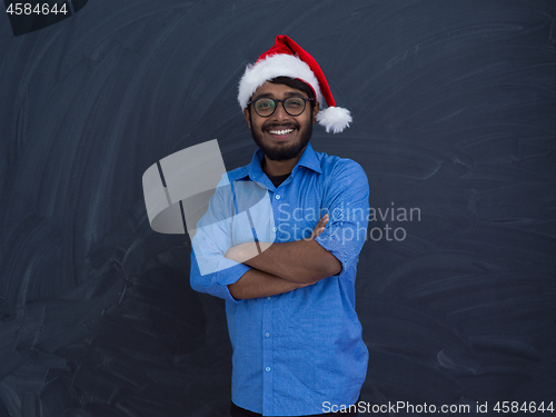 Image of Indian man wearing traditional Santa Claus hat