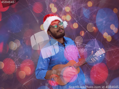 Image of Santa playing Latin America traditional small guitar