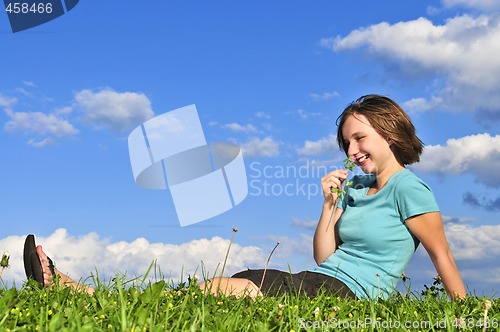 Image of Young girl sitting on grass