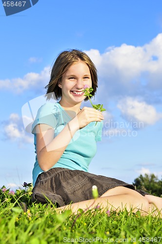 Image of Young girl sitting on grass