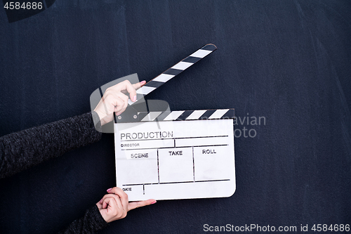 Image of movie clapper on black chalkboard background