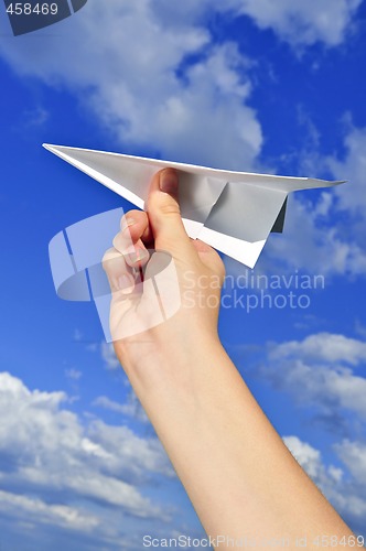 Image of Hand holding paper airplane