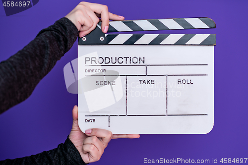 Image of movie clapper on purple violet background