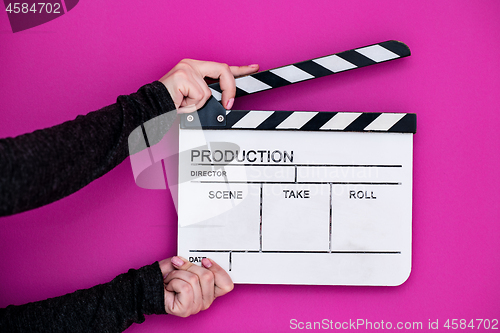 Image of movie clapper on pink purple violet background