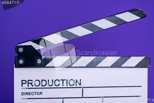 Image of movie clapper on purple violet background