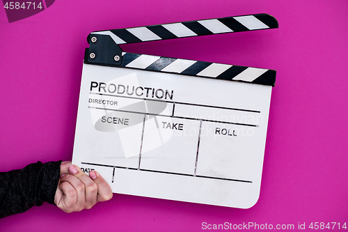 Image of movie clapper on pink purple violet background