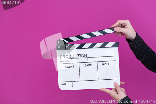 Image of movie clapper on pink purple violet background