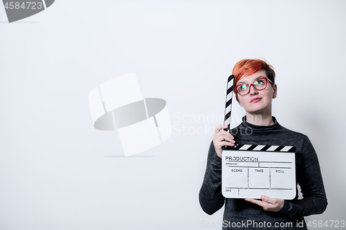 Image of woman on white background holding movie clapper