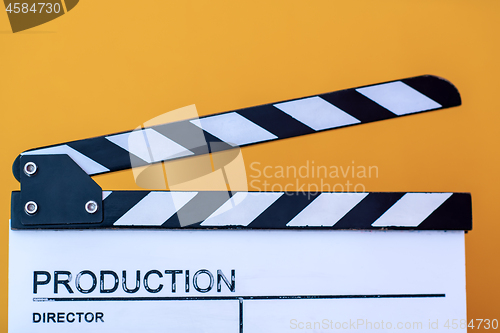 Image of movie clapper isolated on yellow background