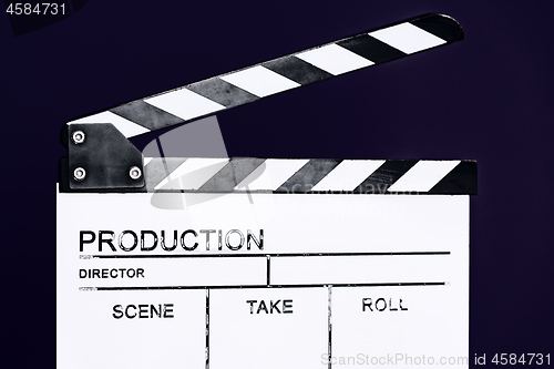 Image of movie clapper on purple violet background