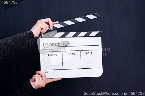 Image of movie clapper on black chalkboard background