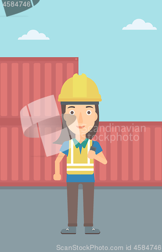 Image of Stevedore standing on cargo containers background.