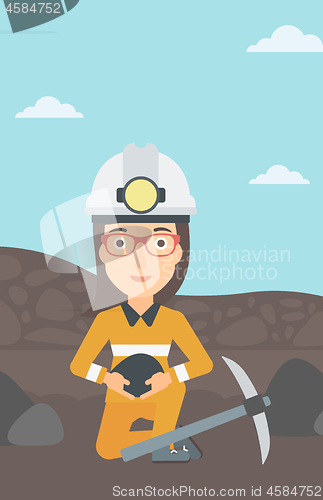 Image of Miner holding coal in hands.