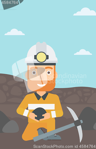 Image of Miner holding coal in hands.