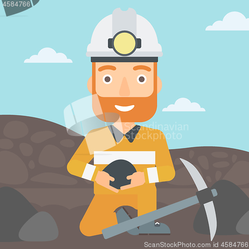 Image of Miner holding coal in hands.