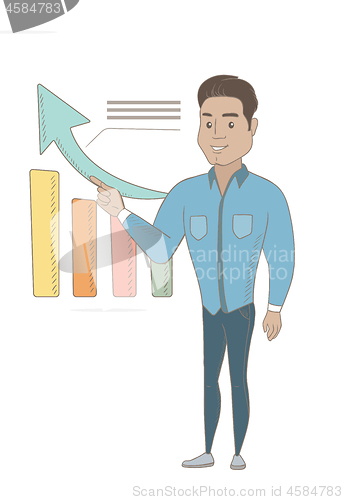 Image of Young hispanic businessman pointing at chart.