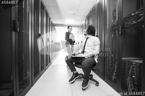 Image of Team of young technicians working together on servers