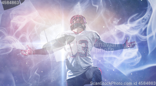 Image of american football player celebrating after scoring a touchdown