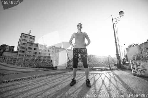 Image of portrait of a jogging woman at sunny morning