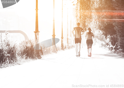 Image of young couple jogging  in the city