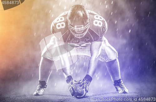 Image of American football player starting football game