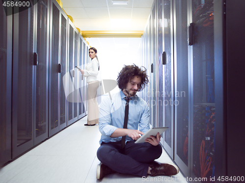 Image of young technicians working together on servers