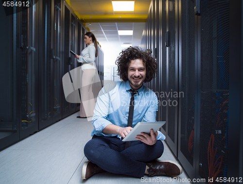 Image of young technicians working together on servers