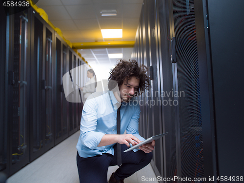 Image of young technicians working together on servers