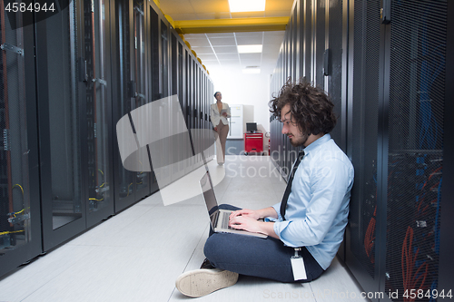 Image of Team of young technicians working together on servers