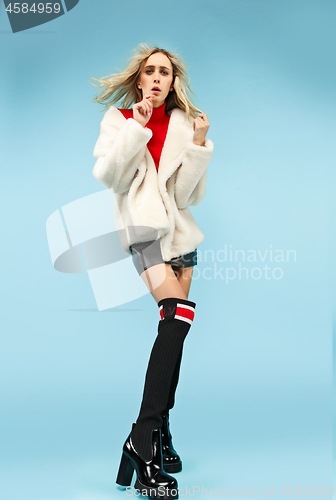 Image of Full-length portrait young elegant woman at studio. Female fashion and shopping concept