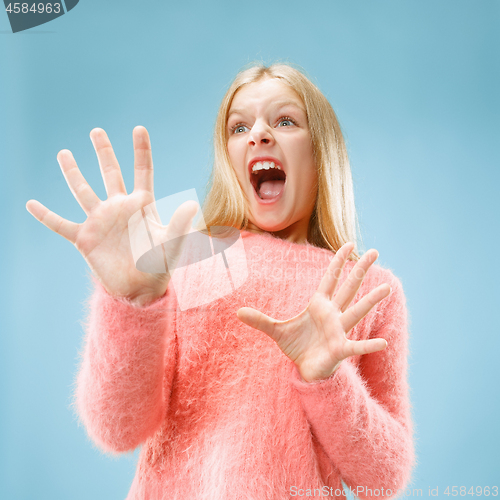 Image of Portrait of the scared girl on blue