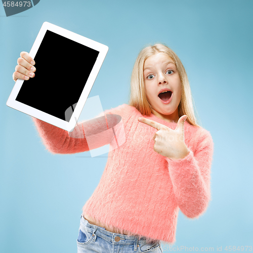 Image of Little funny girl with tablet on blue background