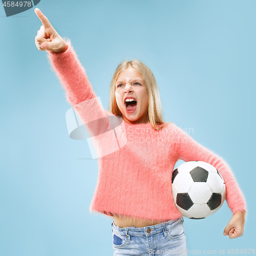 Image of Fan sport teen player holding soccer ball isolated on blue background