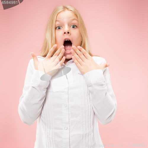 Image of Beautiful teen girl looking suprised isolated on pink