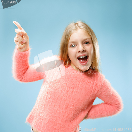 Image of Beautiful teen girl looking suprised isolated on blue