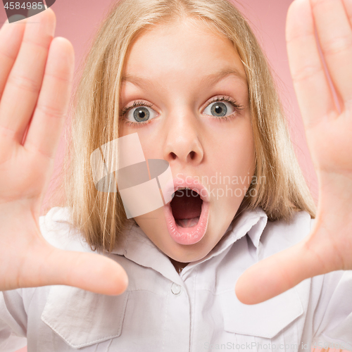 Image of Beautiful teen girl looking suprised isolated on pink