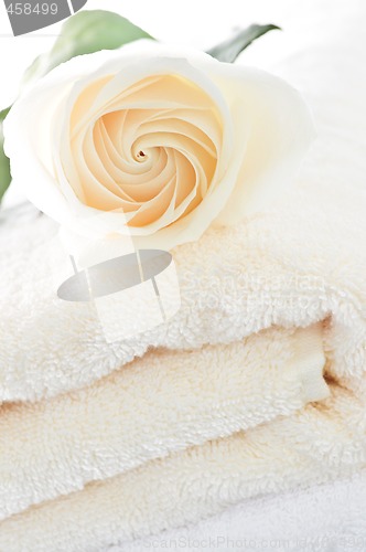 Image of Stack of towels and rose