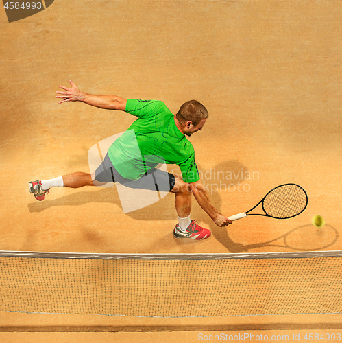 Image of The one jumping player, caucasian fit man, playing tennis on the earthen court