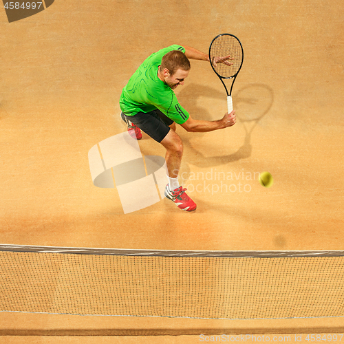 Image of The one jumping player, caucasian fit man, playing tennis on the earthen court