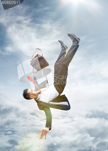 Image of frightened businessman falling down and screaming