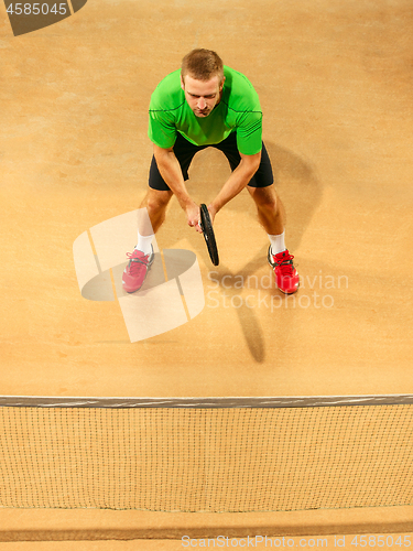 Image of The one jumping player, caucasian fit man, playing tennis on the earthen court