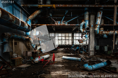 Image of Dark industrial interior with pipes