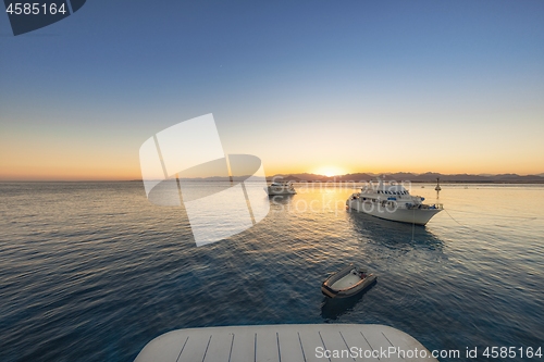 Image of Luxury yacht docking near coral reef