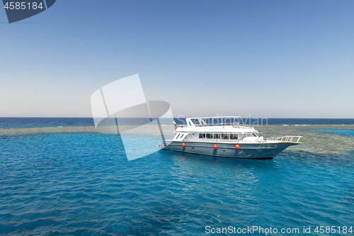 Image of Luxury yacht docking near coral reef