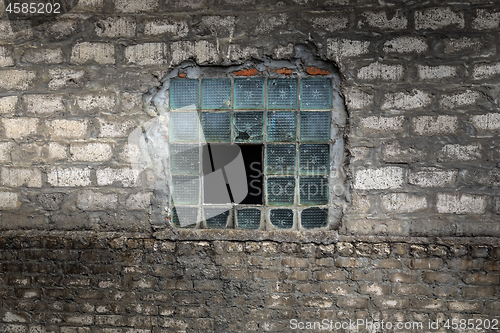 Image of Broken window on abandoned factory wall